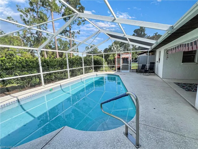 View of pool with a patio and a lanai