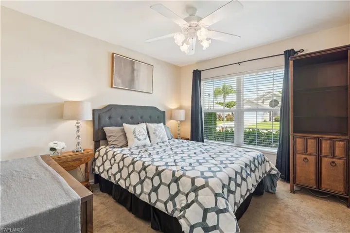 Bedroom featuring ceiling fan and light colored carpet