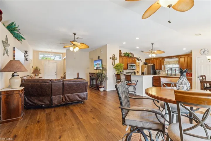 Dining area with light wood-type flooring and ceiling fan