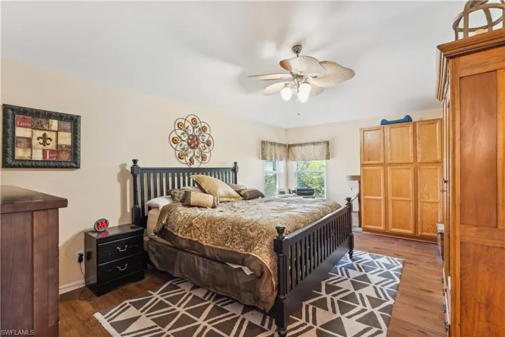 Bedroom featuring ceiling fan and dark wood-type flooring