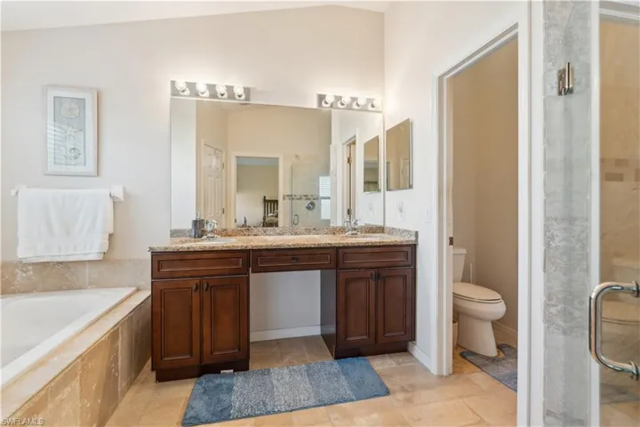 Full bathroom featuring vanity, plus walk in shower, and toilet