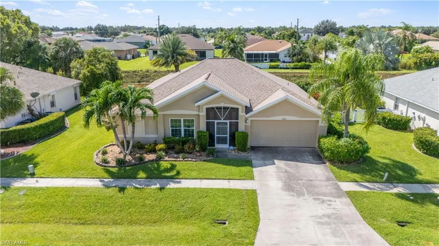 View of front of home featuring a garage and a front lawn
