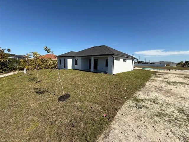 Back of property featuring a yard