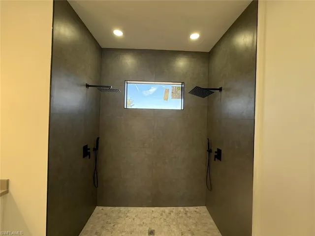 Bathroom featuring tiled shower