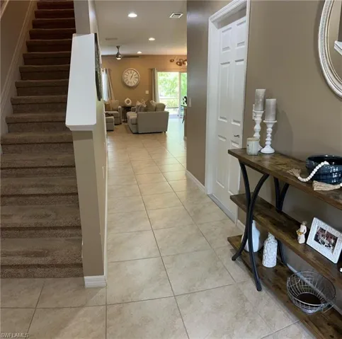 Hall featuring light tile patterned floors