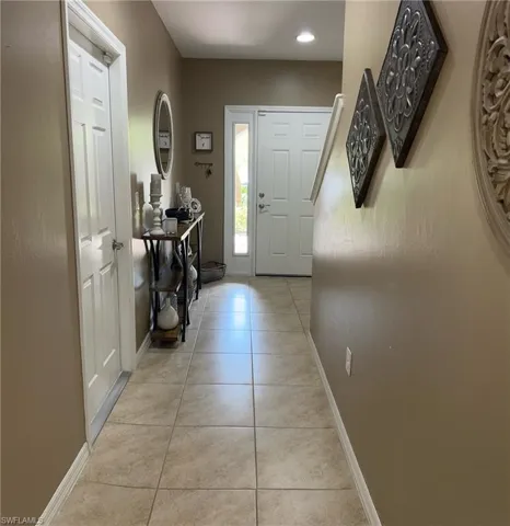 Foyer entrance featuring light tile patterned floors