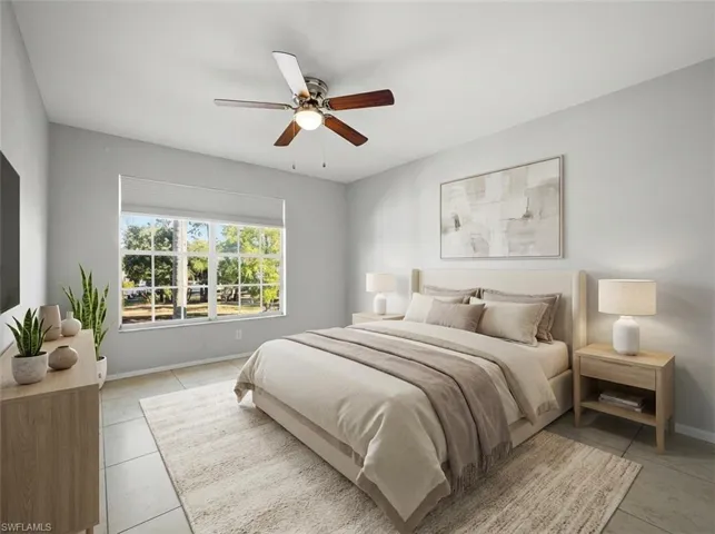 Spacious Primary bedroom featuring light gray walls, large window with natural light, tiled flooring, and a ceiling fan with integrated lighting