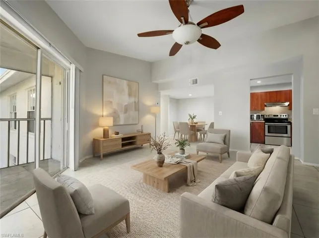 Open-concept living space featuring light gray walls and tiled flooring