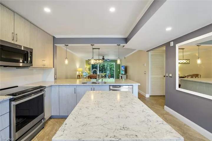 Quartz Countertops/Island, GE Advantium Cooktop, GE Profile Dishwasher, Custom Lighting