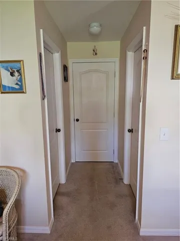 Corridor featuring carpet floors