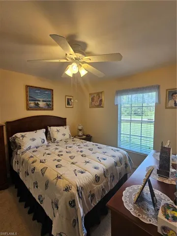 Bedroom featuring ceiling fan and carpet floors