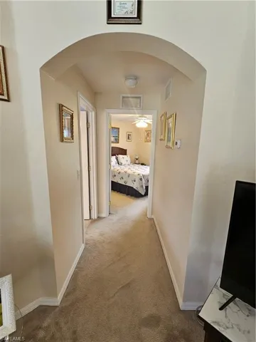 Hallway featuring carpet flooring