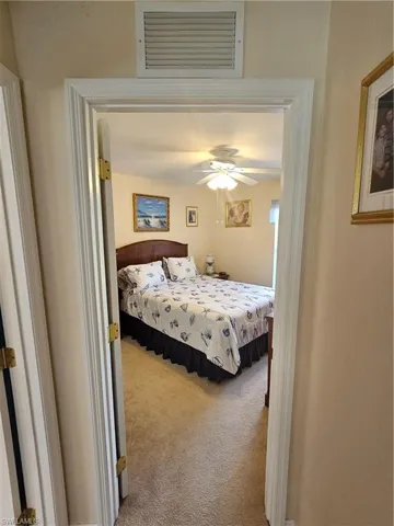 Bedroom featuring light colored carpet and ceiling fan