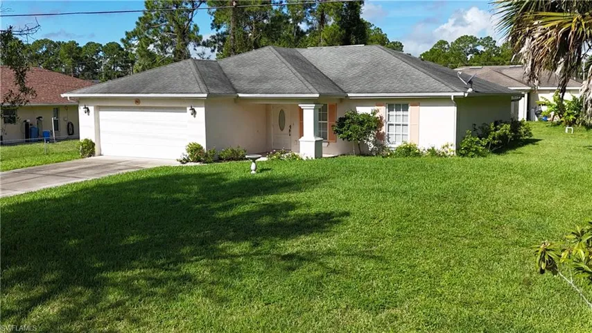 Ranch-style home with a garage and a front yard