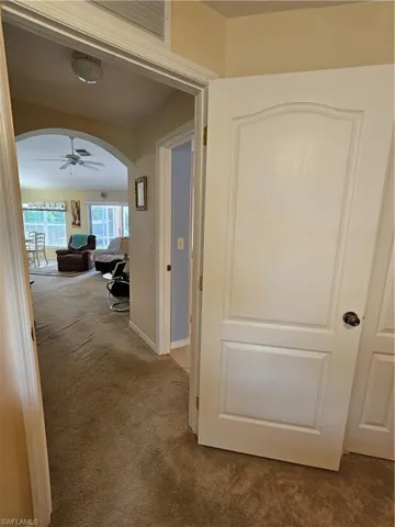 Hall featuring carpet flooring