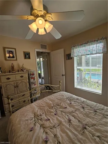 Bedroom with ceiling fan and carpet