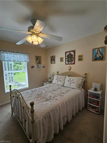Bedroom with ceiling fan and carpet flooring