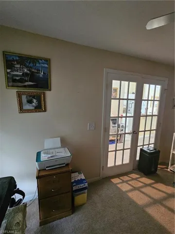 Doorway to outside featuring carpet floors