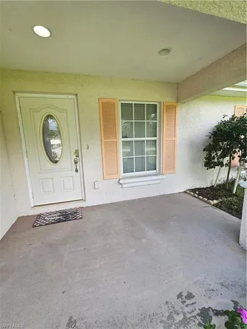 Property entrance featuring a patio area