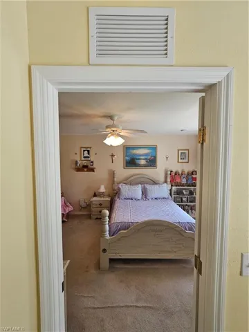Bedroom with ceiling fan and carpet floors