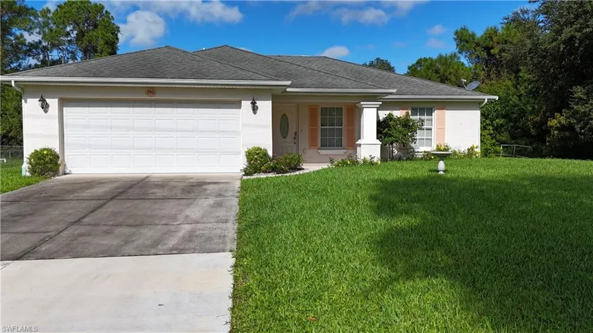 View of front of home featuring a garage and a front lawn