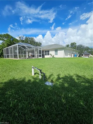 View of yard featuring glass enclosure