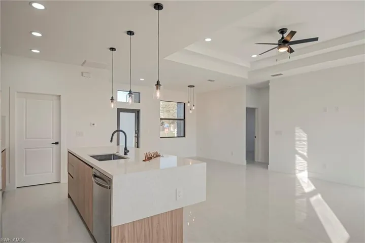 Bedroom featuring a spacious closet, ensuite bath, and a high ceiling