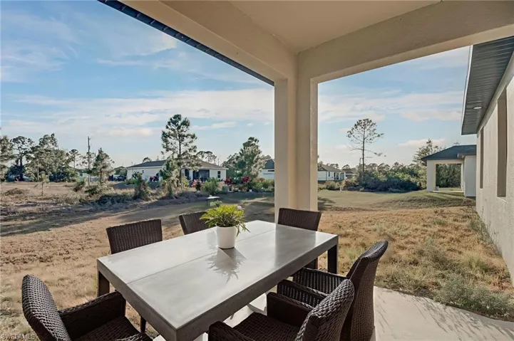 View of patio featuring outdoor dining area and a residential view