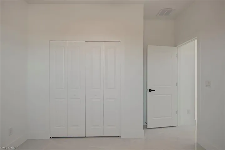 Unfurnished bedroom with baseboards and a closet