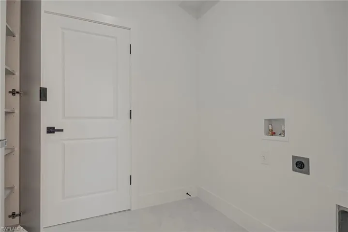 Washroom with hookup for a washing machine and hookup for an electric dryer