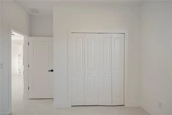 Unfurnished bedroom with a closet and baseboards