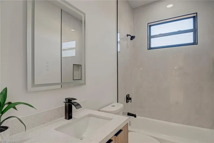 Full bath featuring vanity and shower / tub combination