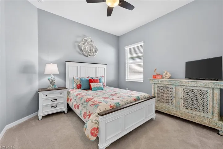 Bedroom featuring light colored carpet and ceiling fan