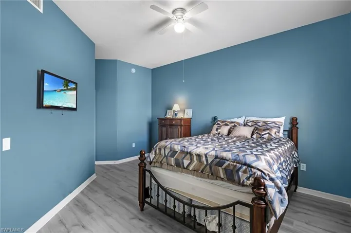 Bedroom with hardwood / wood-style flooring and ceiling fan