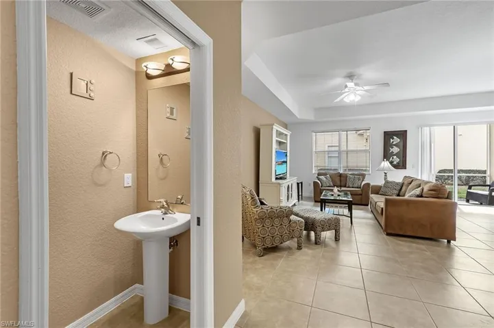 Bathroom featuring ceiling fan and tile patterned flooring