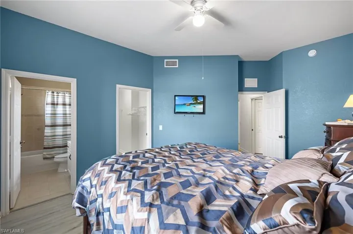 Bedroom featuring connected bathroom, a closet, and ceiling fan
