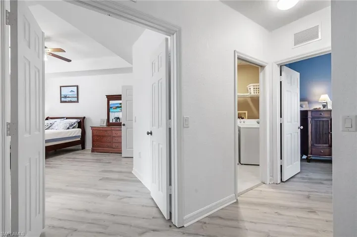 Hall featuring washer / clothes dryer and light hardwood / wood-style flooring