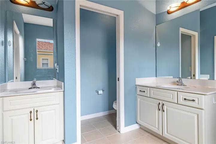 Bathroom featuring tile patterned floors, vanity, and toilet