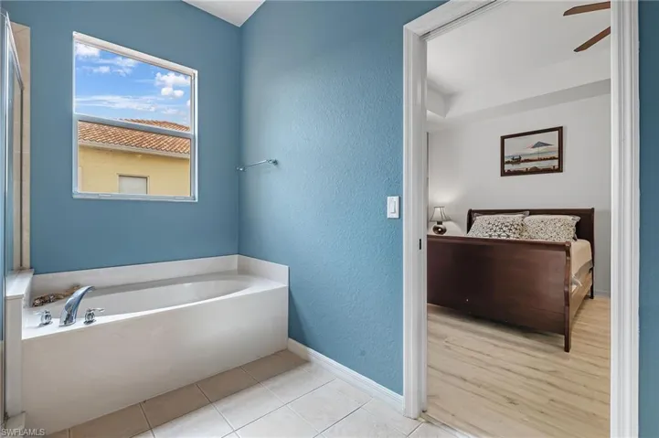 Bathroom with tile patterned flooring and a bathing tub