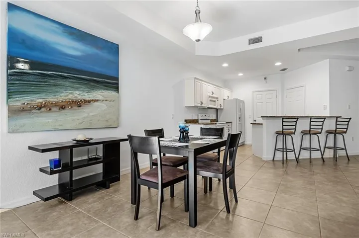 Dining area with light tile patterned floors