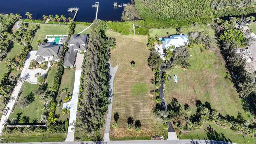 Birds eye view of property with a water view and a rural view