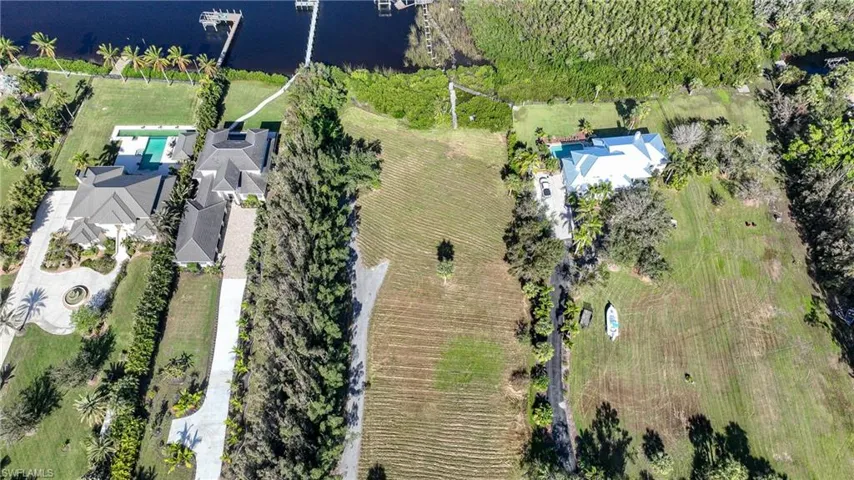 Drone / aerial view with a water view and a rural view