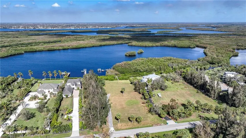 Birds eye view of property with a water view