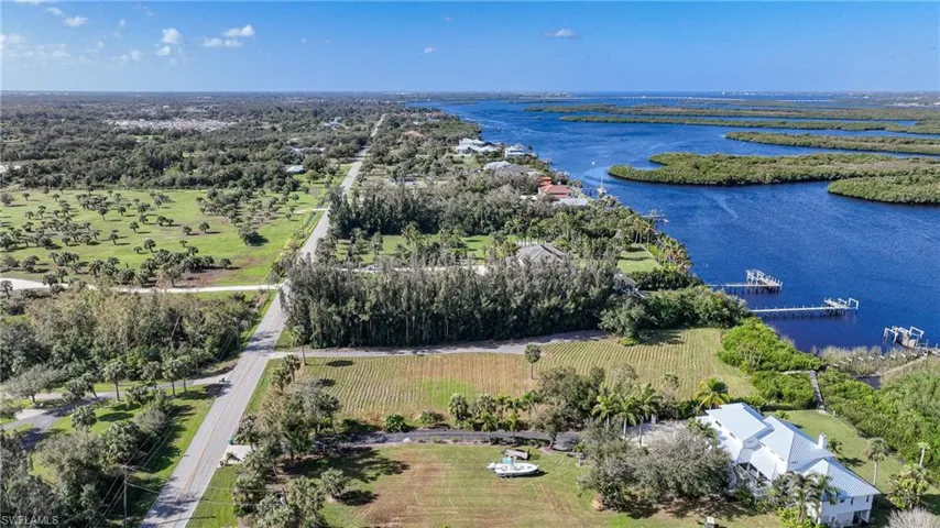 Aerial view featuring a water view and a rural view
