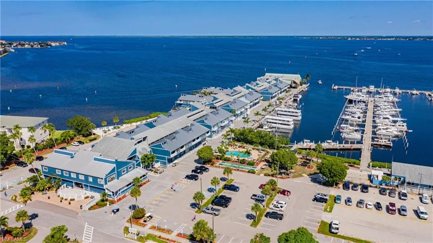 Birds eye view of property with a water view