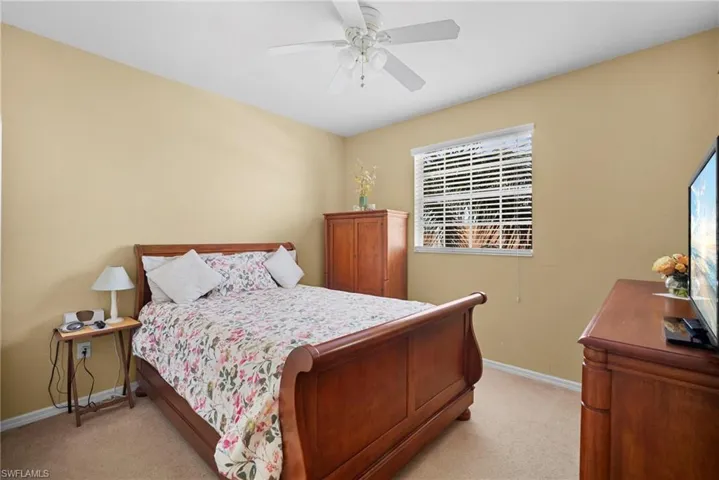 Bedroom featuring light carpet and a ceiling fan