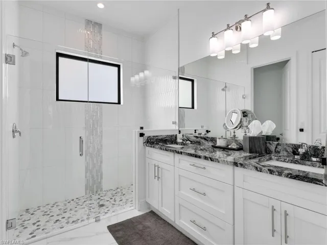 En-Suite Primary Bathroom With Floor to Ceiling Tiled Shower, Tiled Shower Floor, Glass Enclosure, White Shaker Vanity With Drawers & Doors With Dual Sinks, & Quartz Counter
