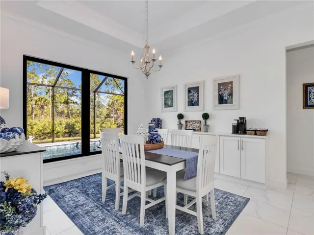 Dining Room With Built-In Bar With Quartz Counter for Extra Storage With Pool & Rear Yard Views