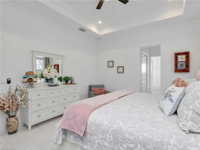 Primary Bedroom With Tray Ceiling and Ceiling Fan