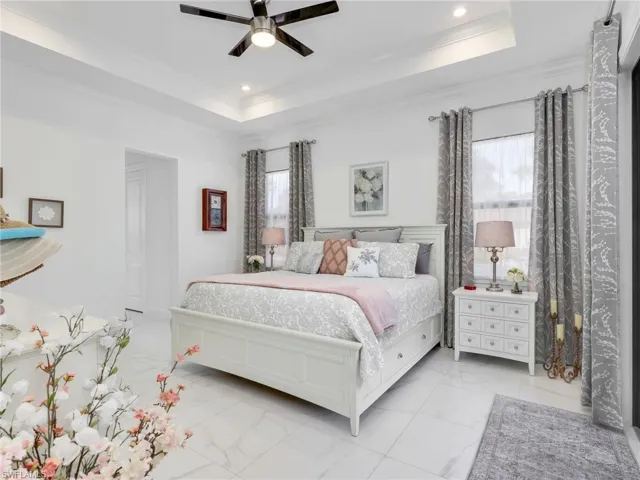 Primary Bedroom With Tray Ceiling & Ceiling Fan